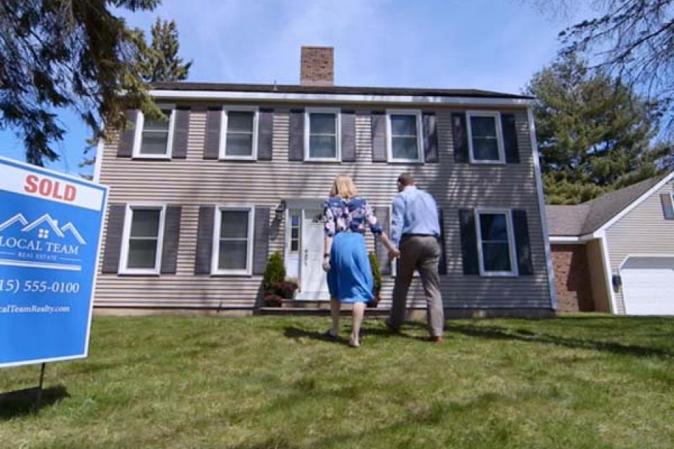 Couple walking into new house