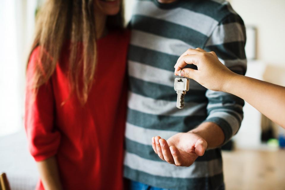 first time homebuyers receiving keys to their new home