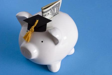 Piggy bank with graduation cap and money
