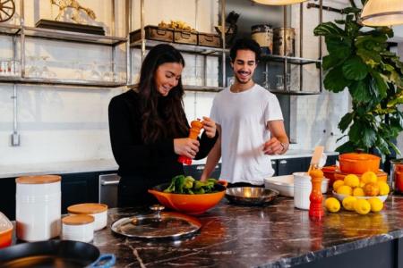 couple in their kitchen cooking dinner