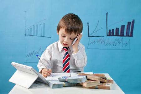 Young boy talking on phone with bar graphs in background